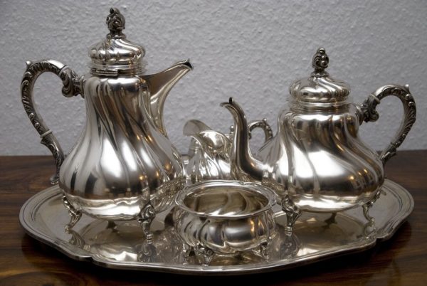 polished silverware on a silver tray