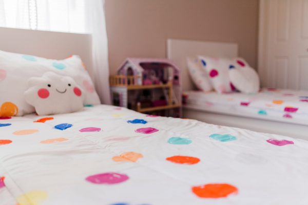 two identical beds with a cute bedsheet cover